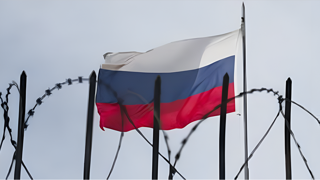 Russian flag behind barbed wire